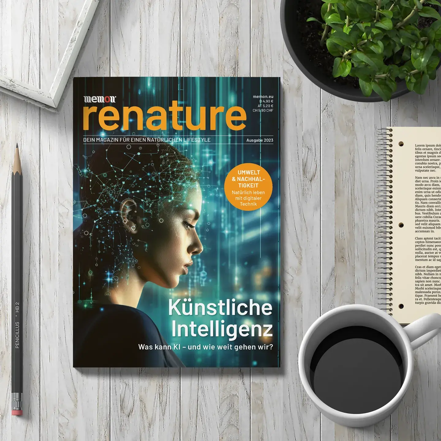 The new memon magazine "renature" lies on a table next to a notepad and a coffee