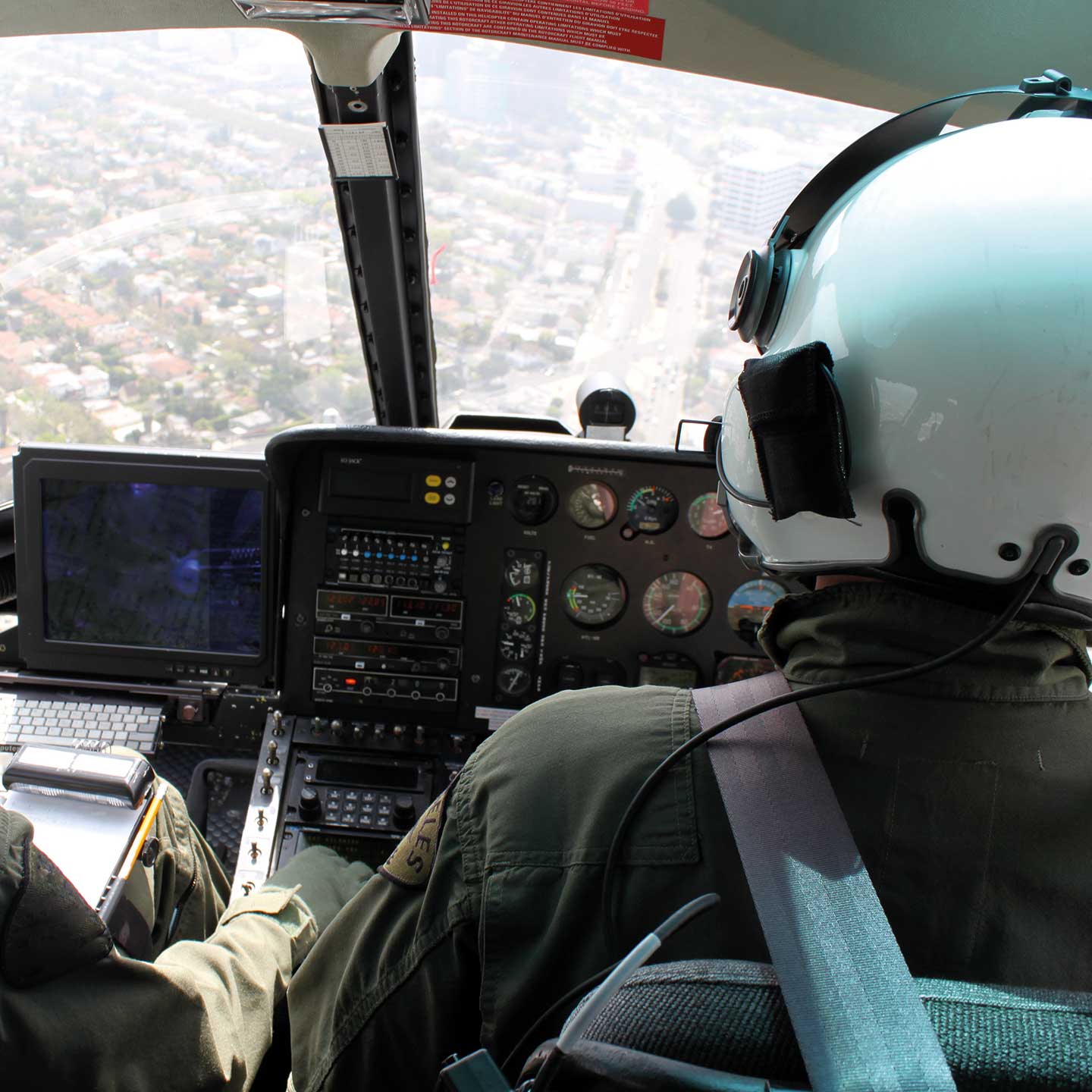 Helicopter cockpit with view over the shoulder of the co-pilot